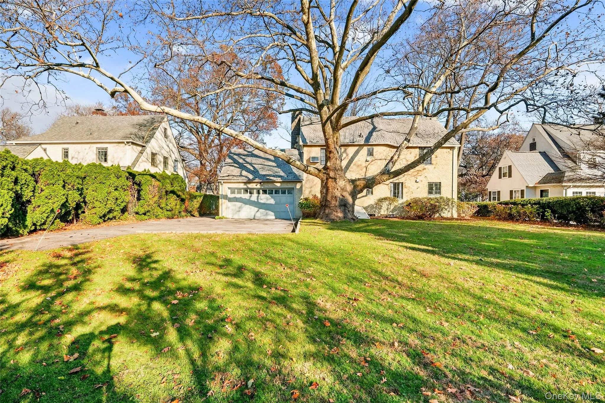 View of front of property with driveway, a garage, and a front lawn View of front of property with driveway, a garage, and a front lawn