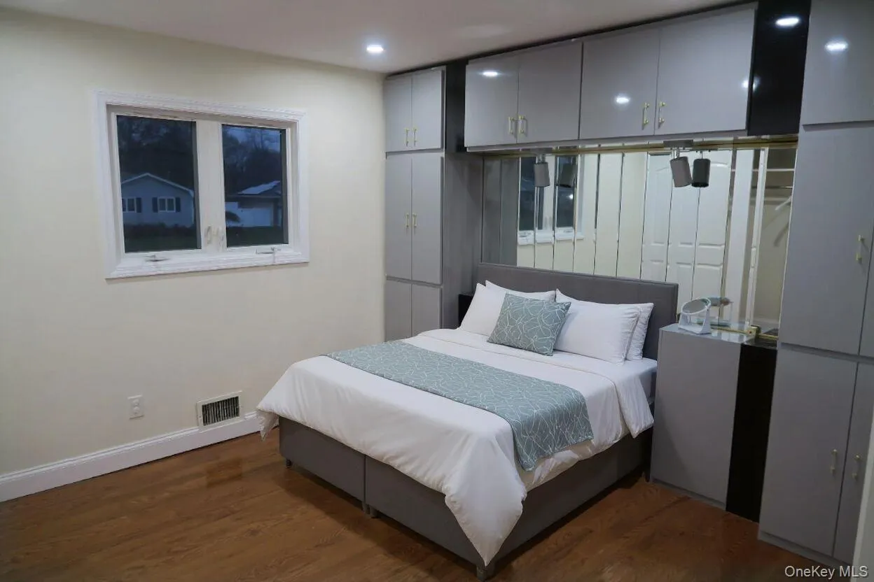 Bedroom featuring dark wood-style floors and recessed lighting Bedroom featuring dark wood-style floors and recessed lighting
