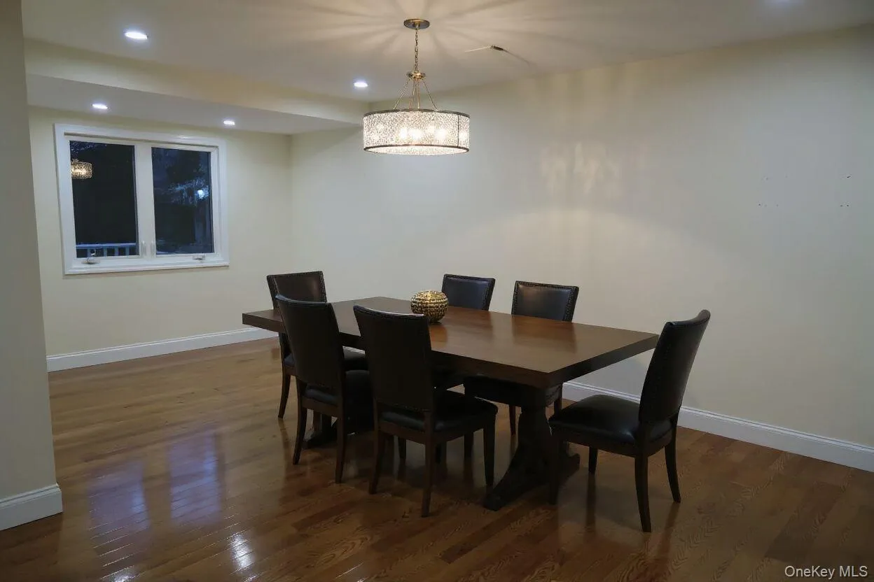 Dining area featuring recessed lighting, dark wood-style floors, and a chandelier Dining area featuring recessed lighting, dark wood-style floors, and a chandelier