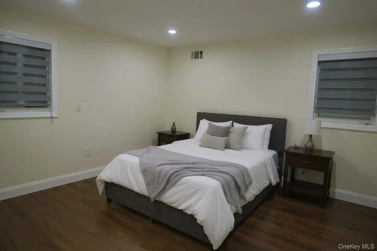 Bedroom featuring recessed lighting and dark wood-type flooring Bedroom featuring recessed lighting and dark wood-type flooring