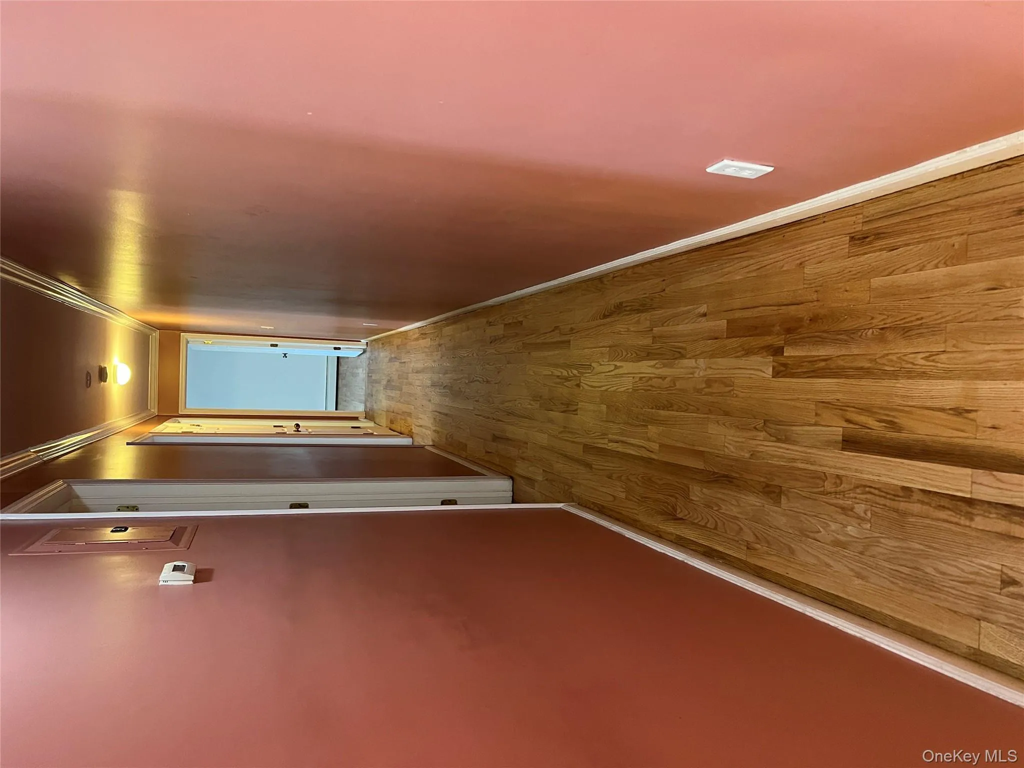 Hall featuring ornamental molding and light wood-style floors Hall featuring ornamental molding and light wood-style floors