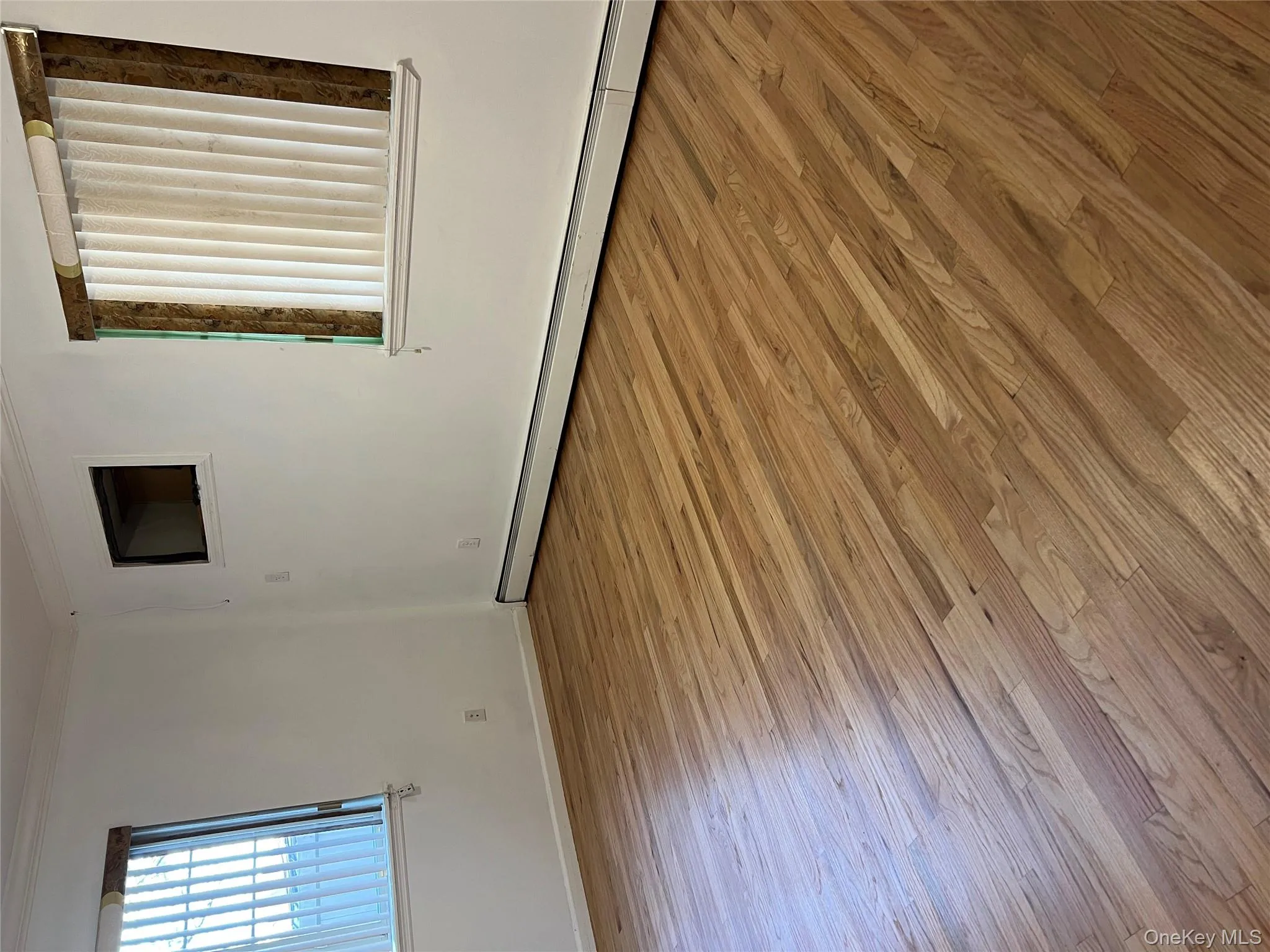 Unfurnished room with baseboard heating, ornamental molding, and light wood-style flooring Unfurnished room with baseboard heating, ornamental molding, and light wood-style flooring