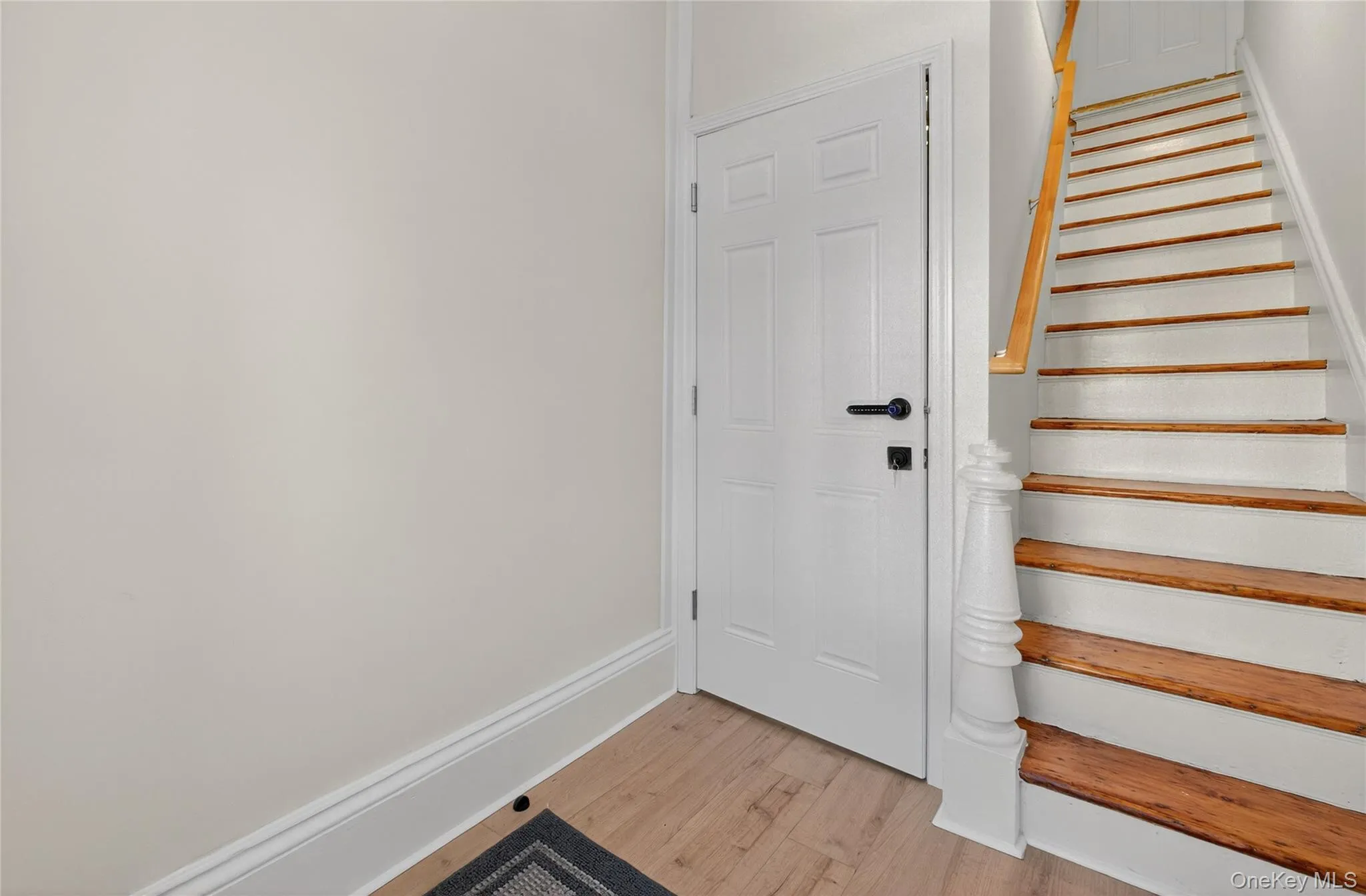 Stairs with baseboards and wood finished floors Stairs with baseboards and wood finished floors