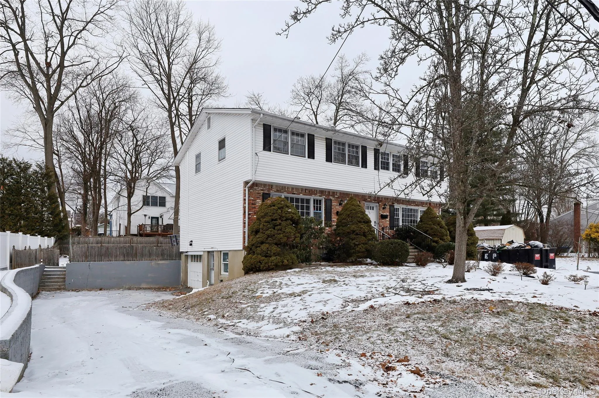 View of front facade featuring brick siding and an attached garage View of front facade featuring brick siding and an attached garage