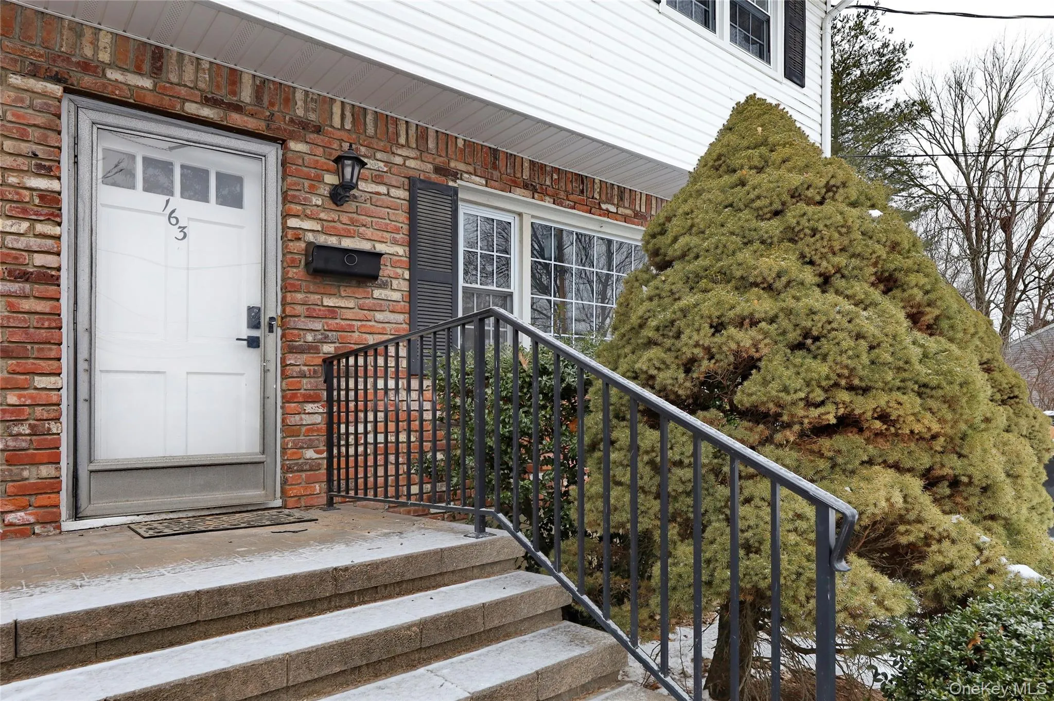 Entrance to property featuring brick siding Entrance to property featuring brick siding