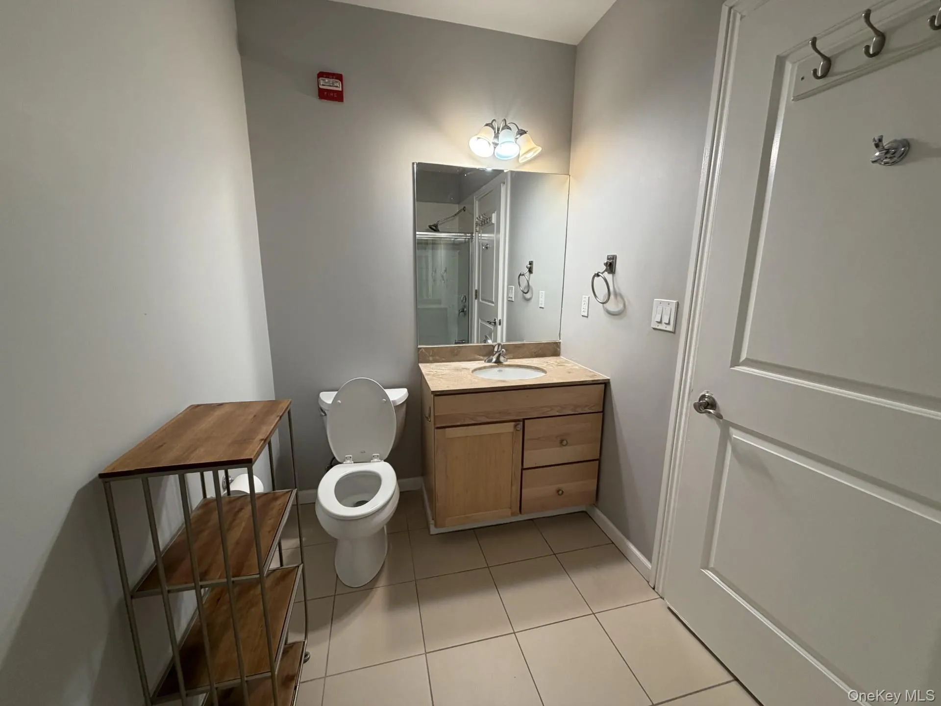 Full bath with vanity, light tile patterned flooring, and a stall shower Full bath with vanity, light tile patterned flooring, and a stall shower
