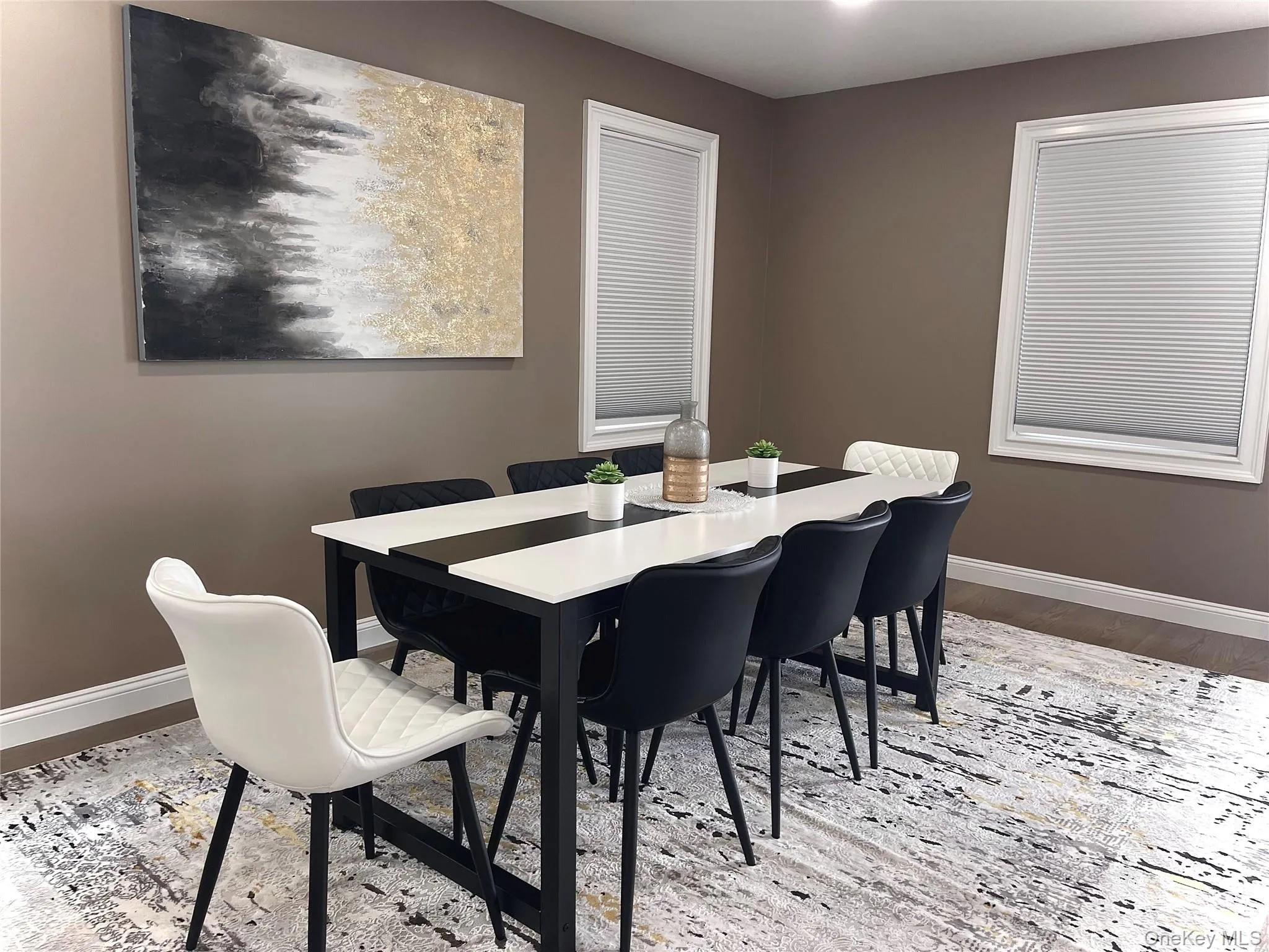 Dining area featuring baseboards and wood finished floors Dining area featuring baseboards and wood finished floors