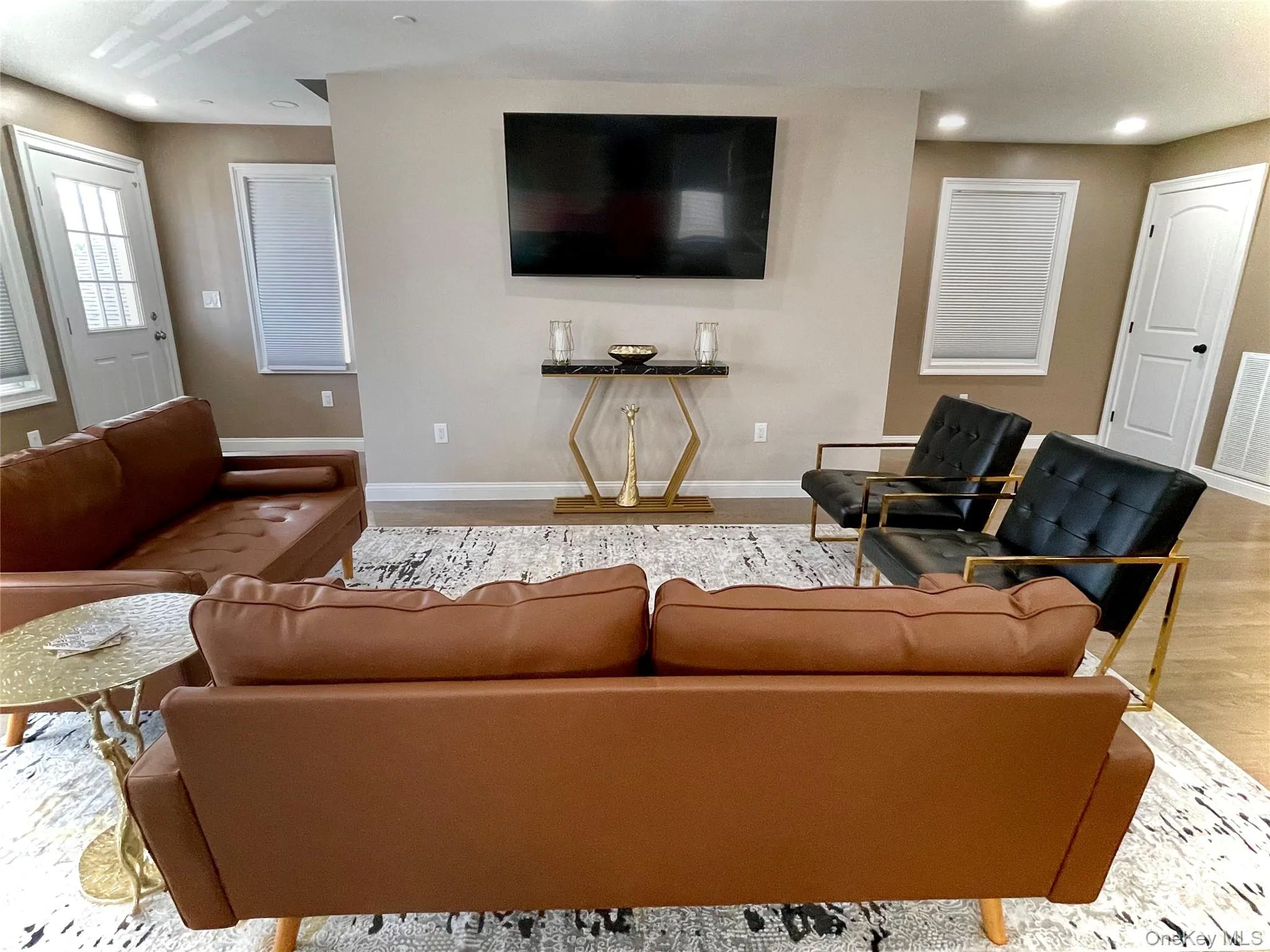 Living room featuring recessed lighting and wood finished floors Living room featuring recessed lighting and wood finished floors