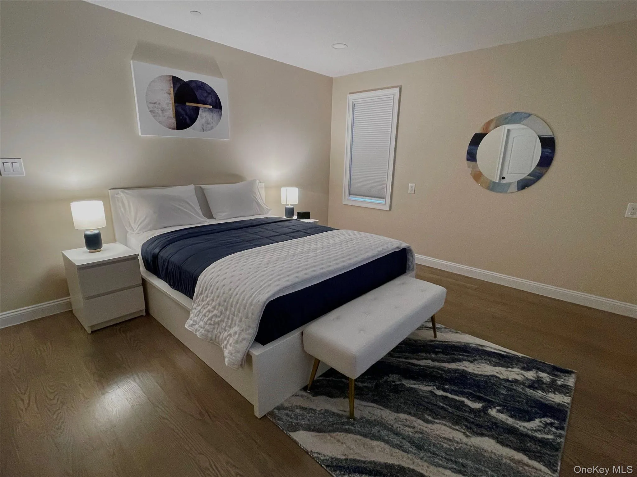 Bedroom with wood finished floors and baseboards Bedroom with wood finished floors and baseboards