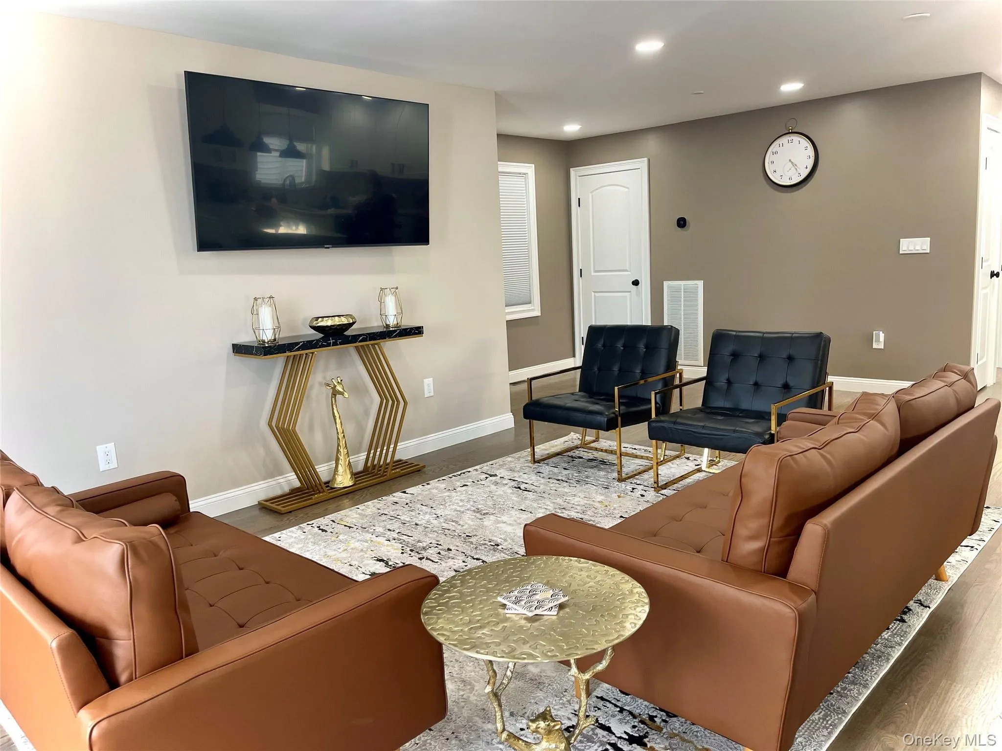 Living area featuring wood finished floors and recessed lighting Living area featuring wood finished floors and recessed lighting