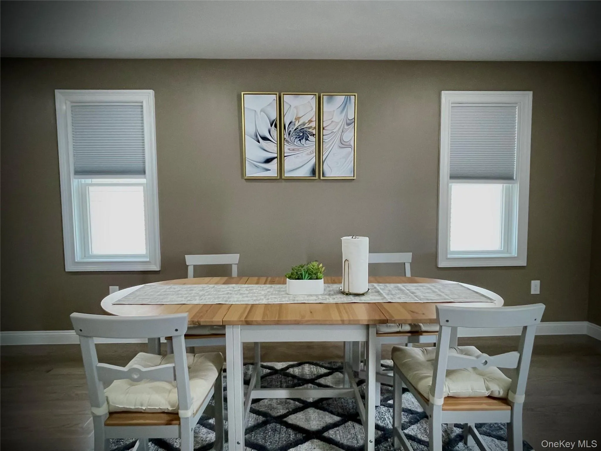 Dining room featuring baseboards and wood finished floors Dining room featuring baseboards and wood finished floors