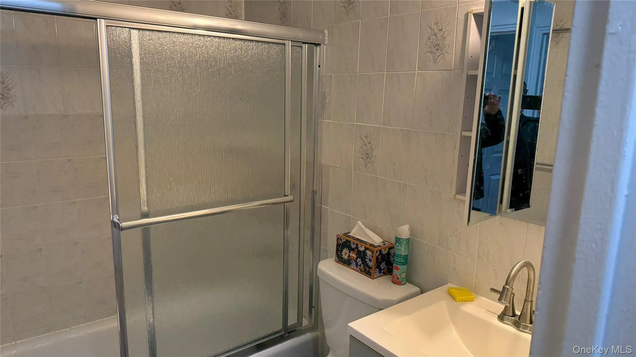 Bathroom featuring vanity and enclosed tub / shower combo Bathroom featuring vanity and enclosed tub / shower combo