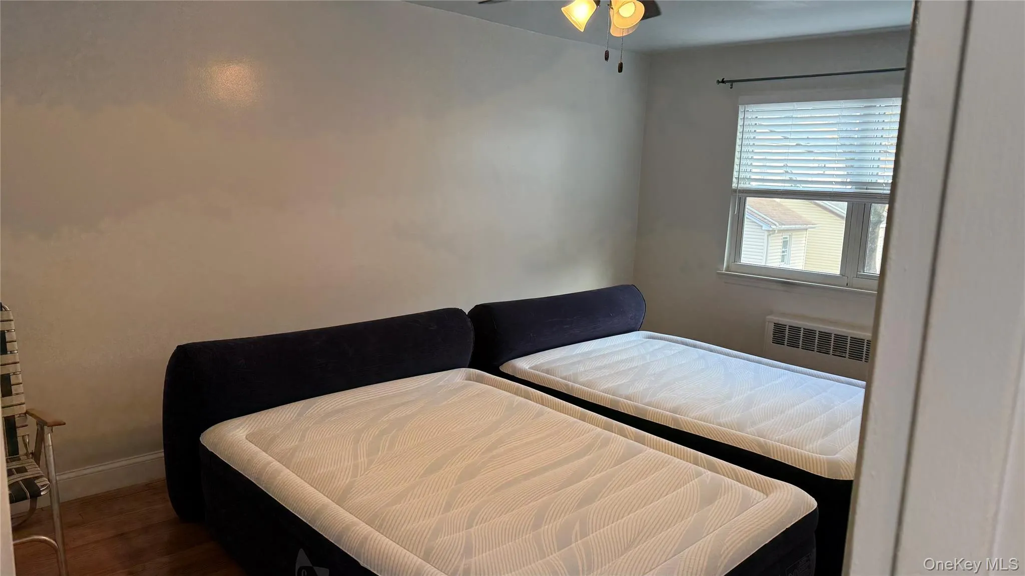 Bedroom featuring wood finished floors and a ceiling fan Bedroom featuring wood finished floors and a ceiling fan
