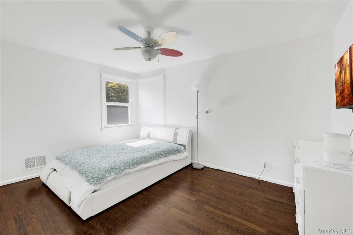 Bedroom featuring wood finished floors and a ceiling fan Bedroom featuring wood finished floors and a ceiling fan