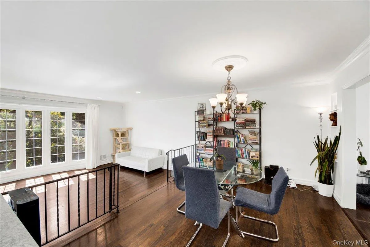 Dining area with wood finished floors, a chandelier, crown molding, and recessed lighting Dining area with wood finished floors, a chandelier, crown molding, and recessed lighting
