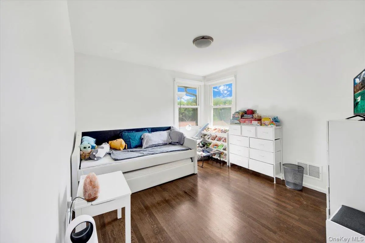 Living area with wood finished floors and baseboards Living area with wood finished floors and baseboards