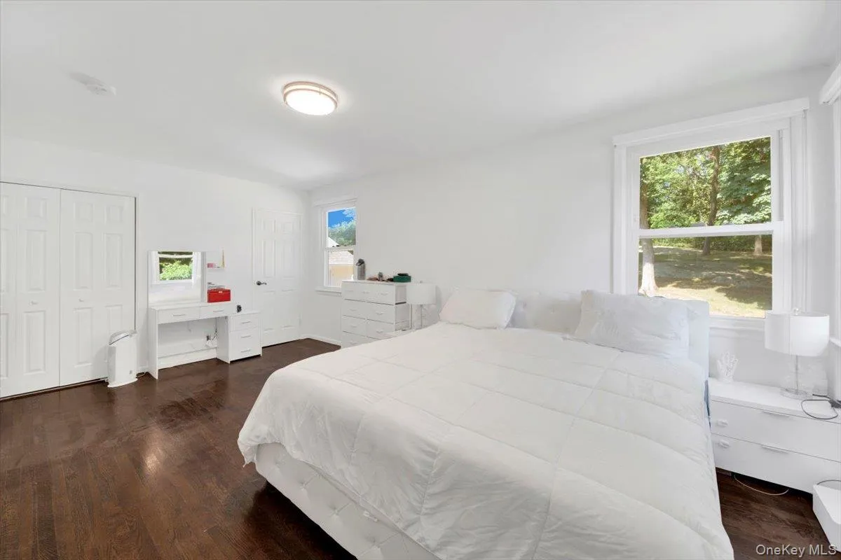 Bedroom featuring dark wood-style flooring Bedroom featuring dark wood-style flooring
