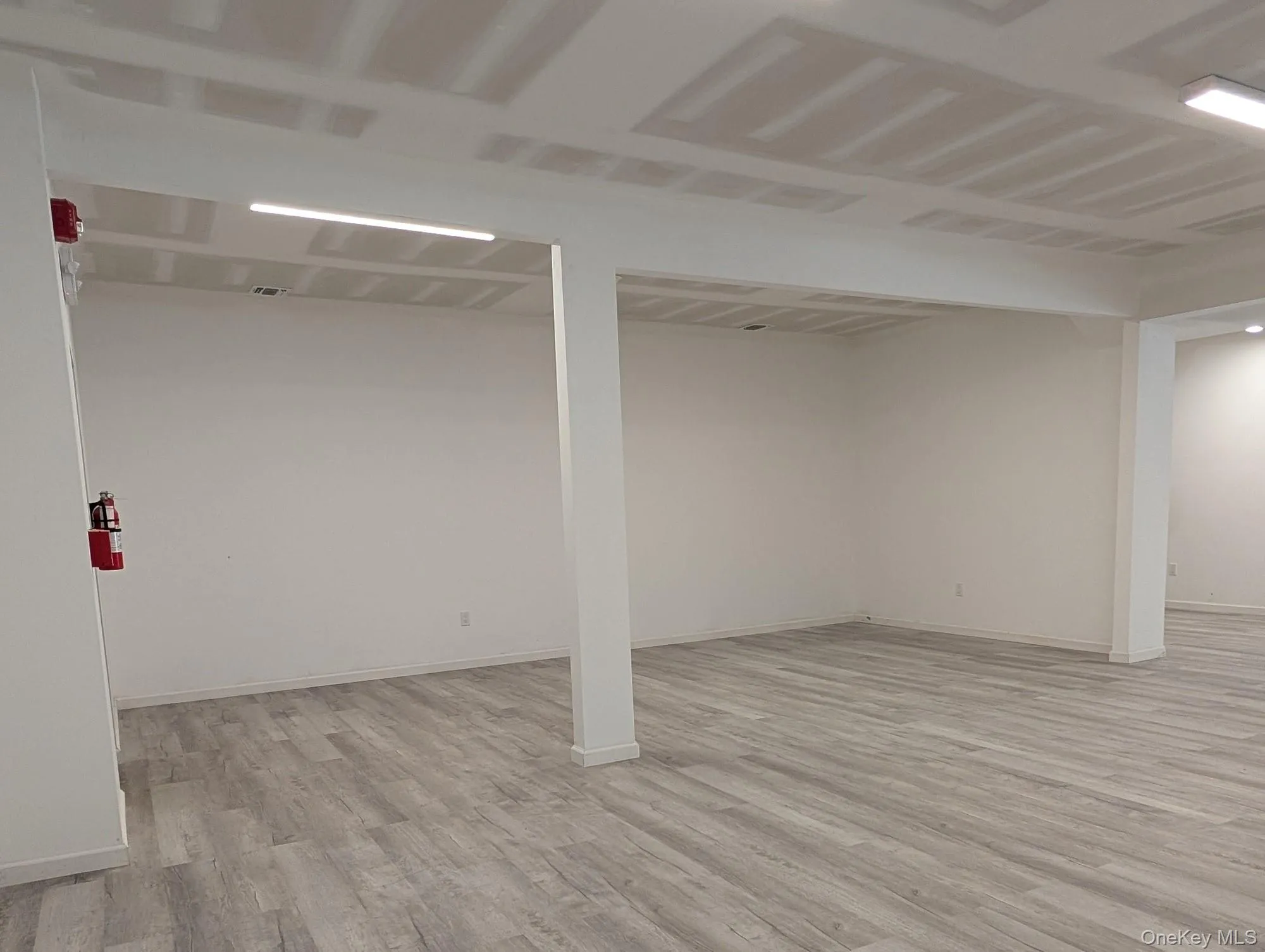 Finished basement with light wood-type flooring and baseboards Finished basement with light wood-type flooring and baseboards