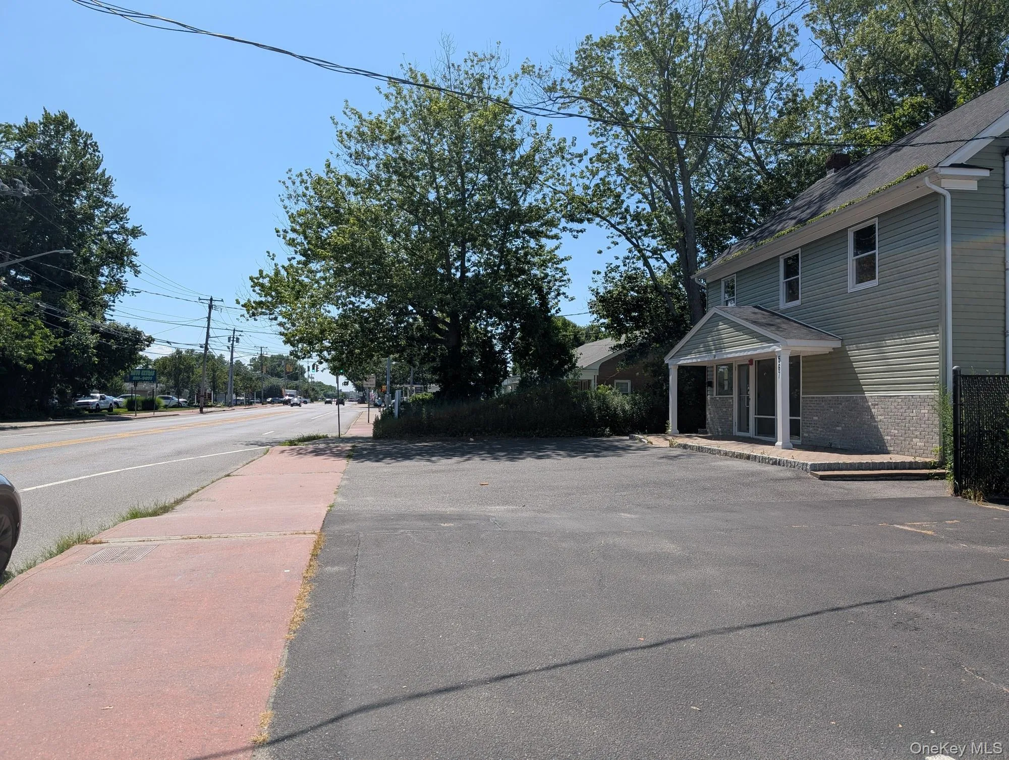 View of asphalt street with sidewalks View of asphalt street with sidewalks