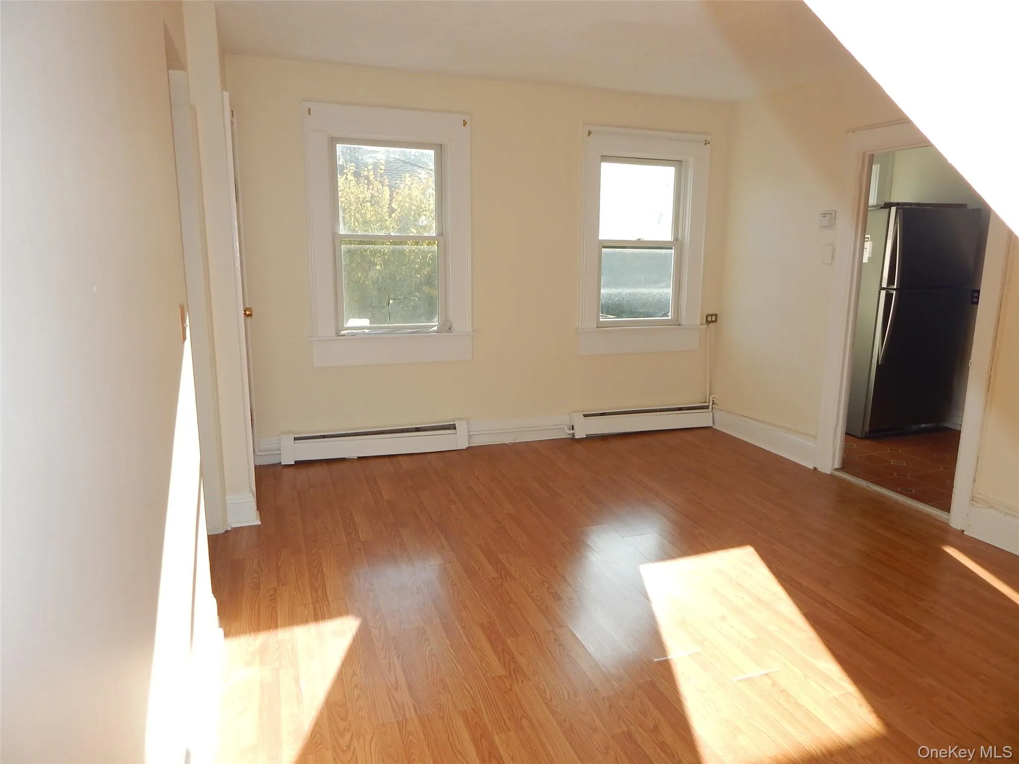 Bonus room featuring plenty of natural light, light wood-style floors, and a baseboard radiator Bonus room featuring plenty of natural light, light wood-style floors, and a baseboard radiator