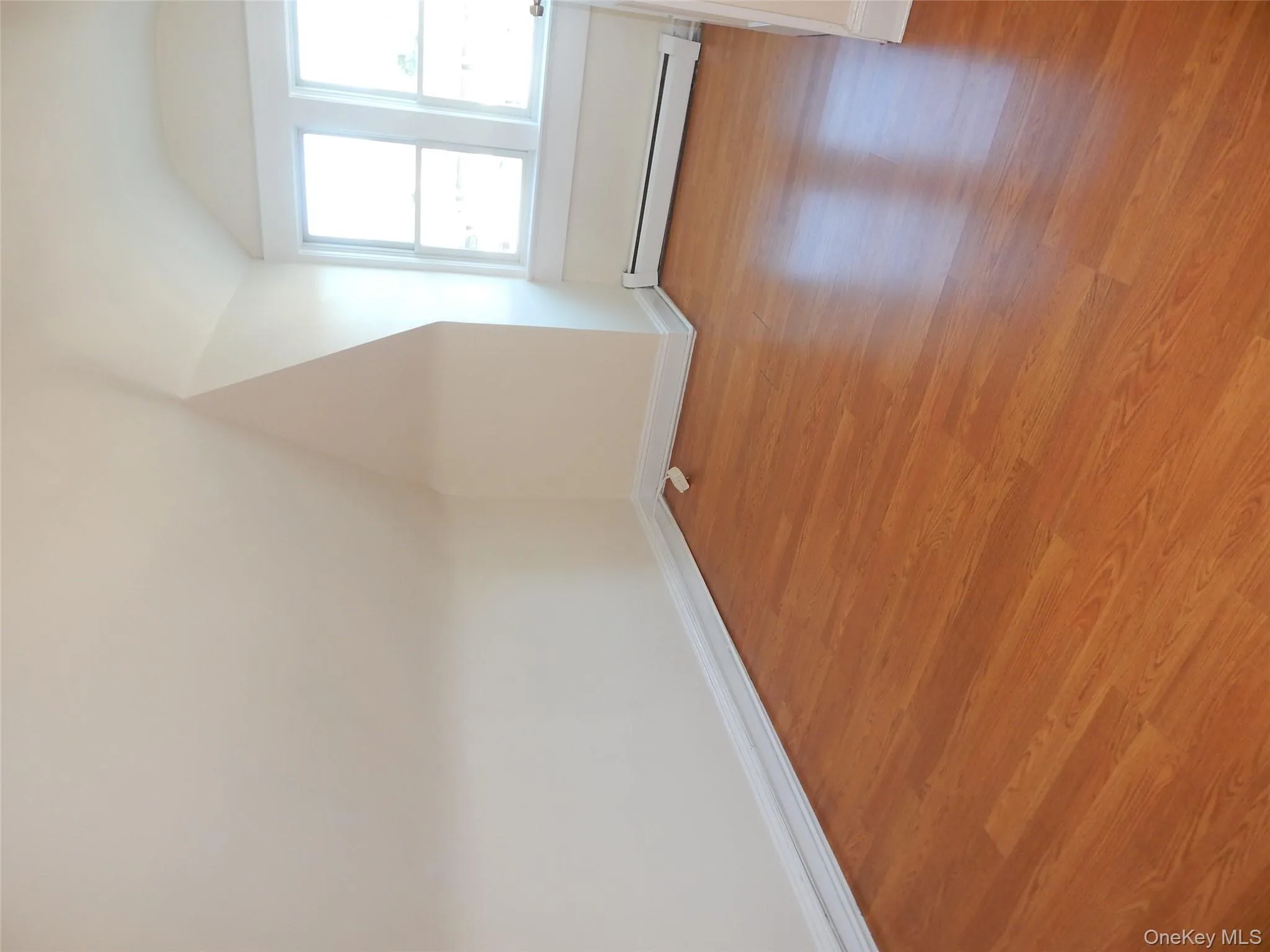 Bonus room with lofted ceiling, a baseboard heating unit, and light wood-style flooring Bonus room with lofted ceiling, a baseboard heating unit, and light wood-style flooring