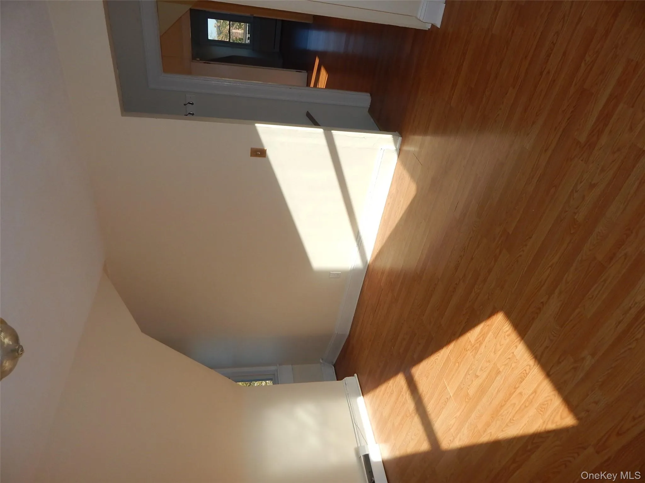 Bonus room with wood finished floors, lofted ceiling, and a baseboard heating unit Bonus room with wood finished floors, lofted ceiling, and a baseboard heating unit