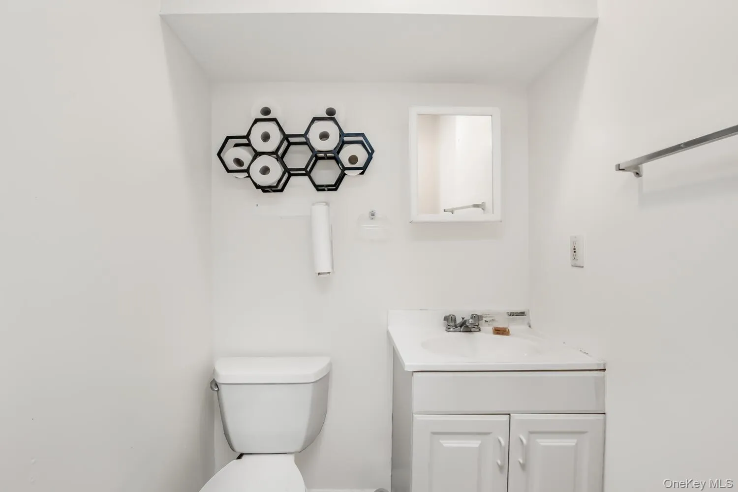 Half bathroom featuring vanity and toilet Half bathroom featuring vanity and toilet