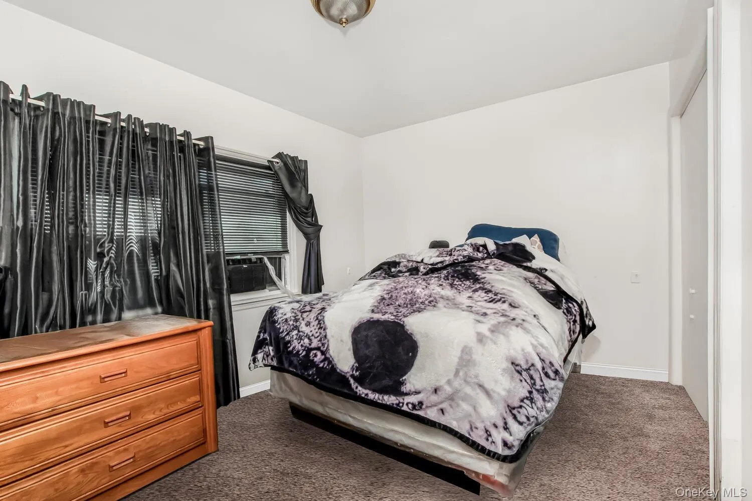 Bedroom featuring carpet flooring and baseboards Bedroom featuring carpet flooring and baseboards