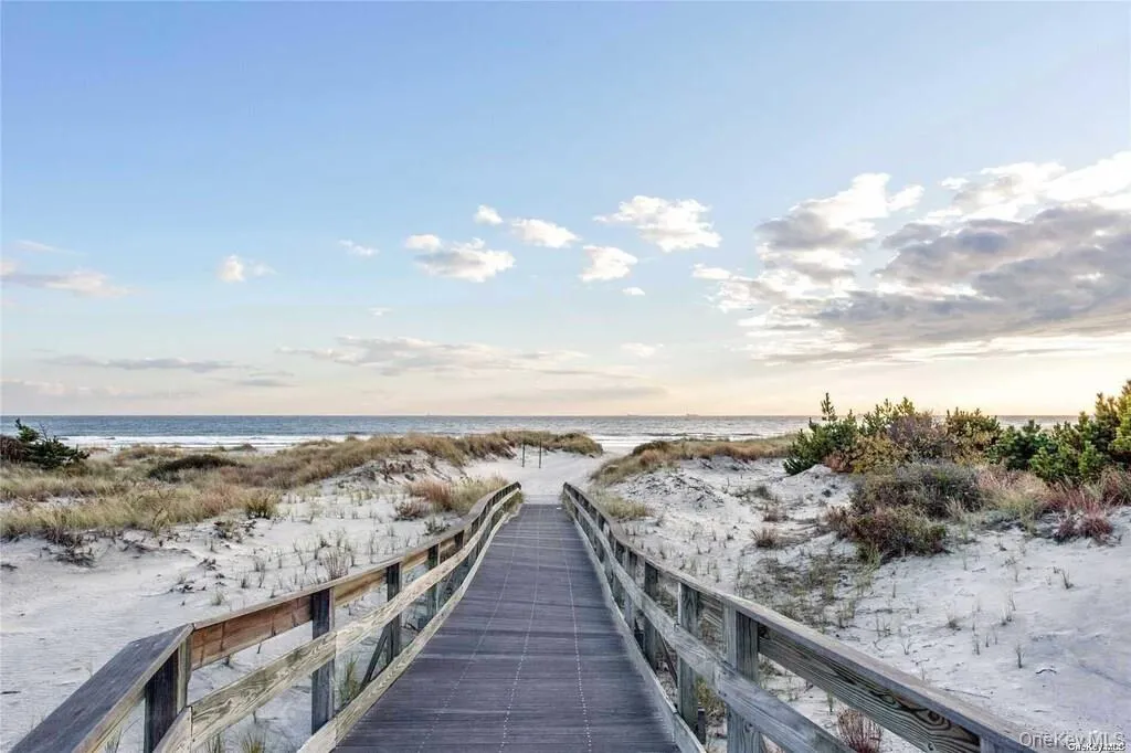 Dock area featuring view of water and beach Dock area featuring view of water and beach