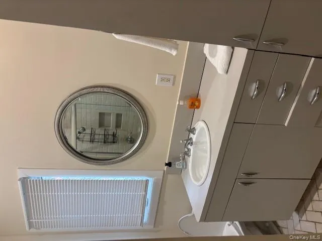 Bathroom featuring vanity and a stall shower Bathroom featuring vanity and a stall shower