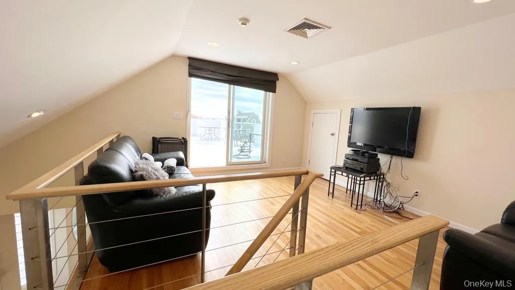 Additional living space with recessed lighting, light wood finished floors, and lofted ceiling Additional living space with recessed lighting, light wood finished floors, and lofted ceiling