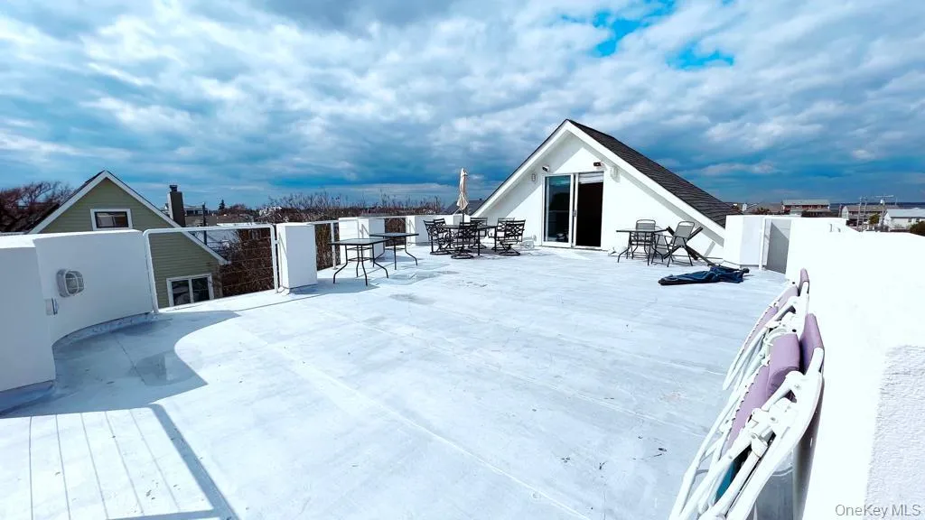 Wooden deck with outdoor dining area and a patio Wooden deck with outdoor dining area and a patio