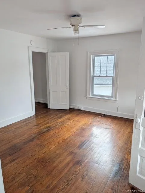 Empty room with hardwood / wood-style floors and a ceiling fan Empty room with hardwood / wood-style floors and a ceiling fan