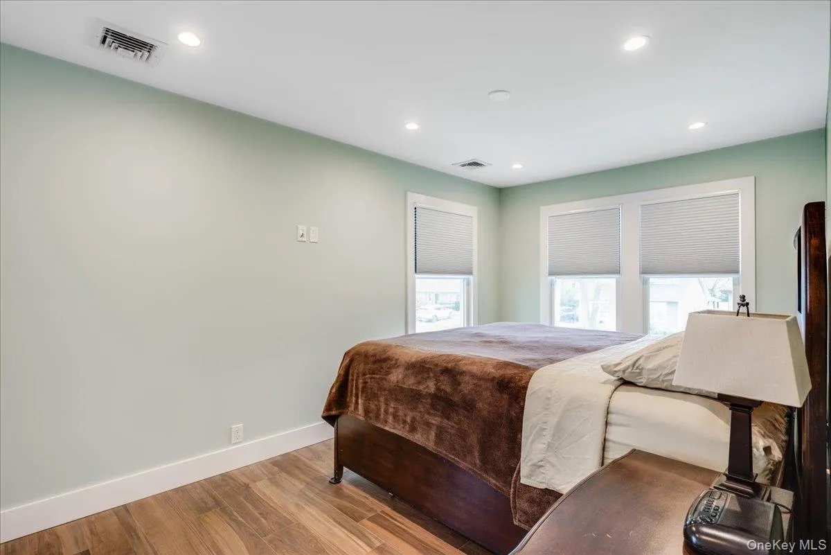 Bedroom with wood finished floors and recessed lighting Bedroom with wood finished floors and recessed lighting