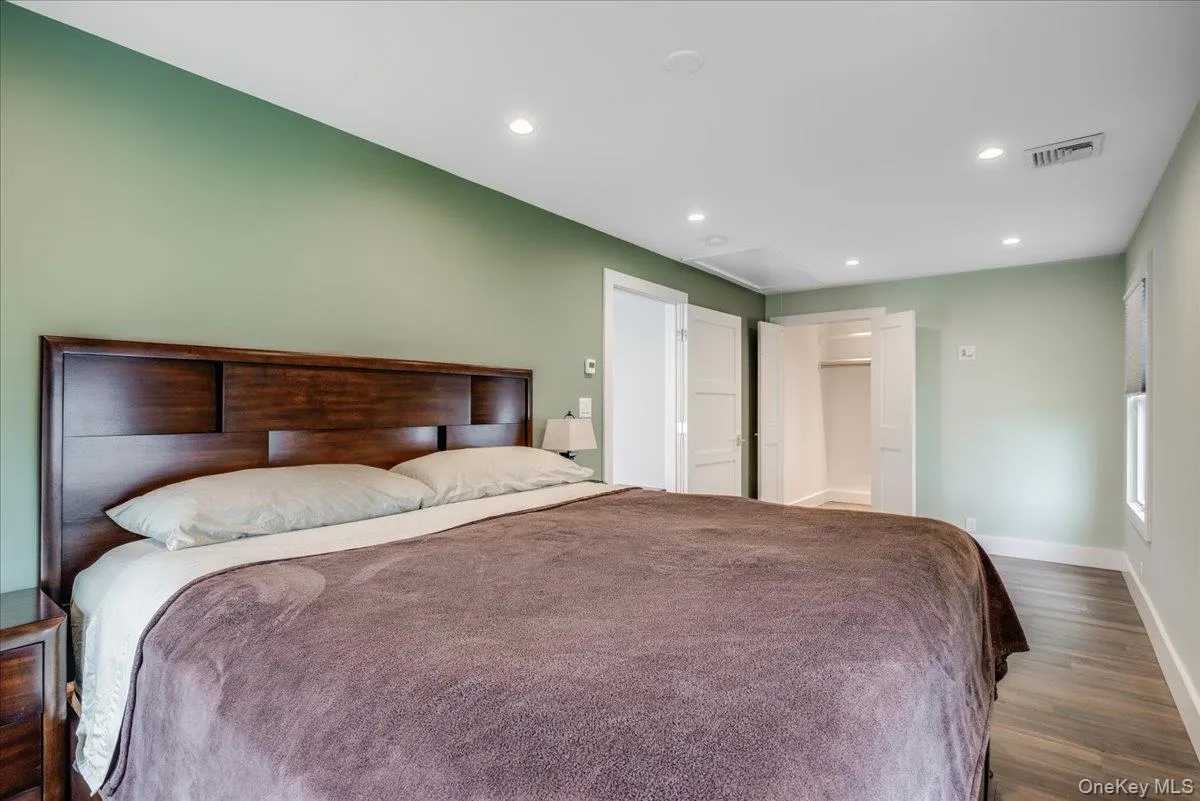 Bedroom featuring recessed lighting and wood finished floors Bedroom featuring recessed lighting and wood finished floors