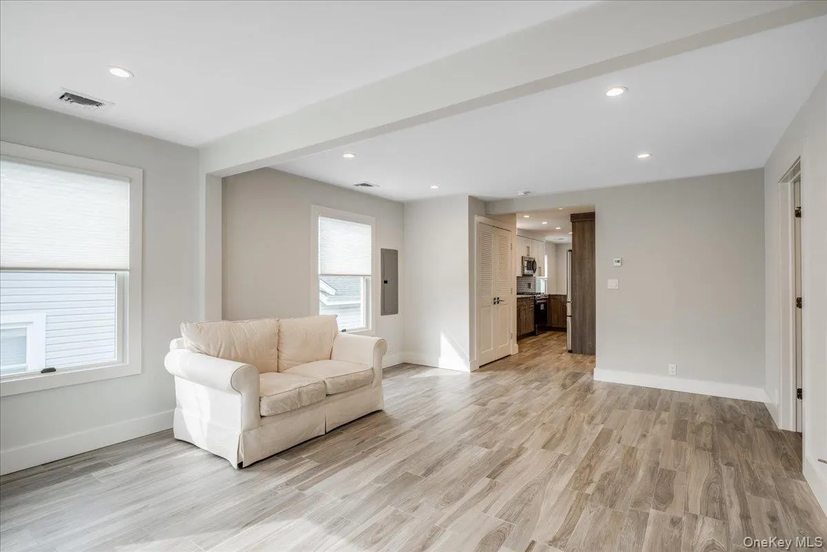 Sitting room with light wood-style flooring, recessed lighting, and electric panel Sitting room with light wood-style flooring, recessed lighting, and electric panel
