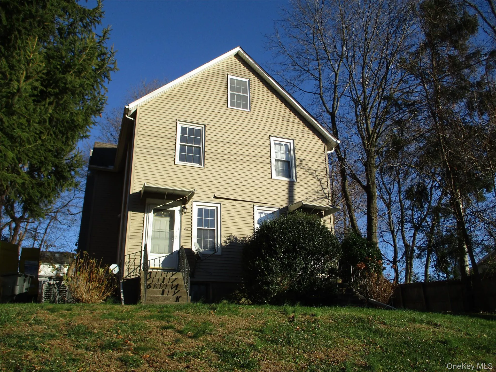 Rear view of house featuring a lawn Rear view of house featuring a lawn