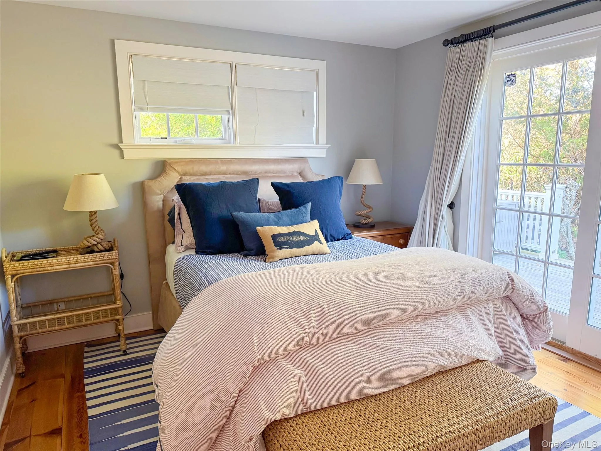 Bedroom with hardwood / wood-style floors and access to exterior Bedroom with hardwood / wood-style floors and access to exterior