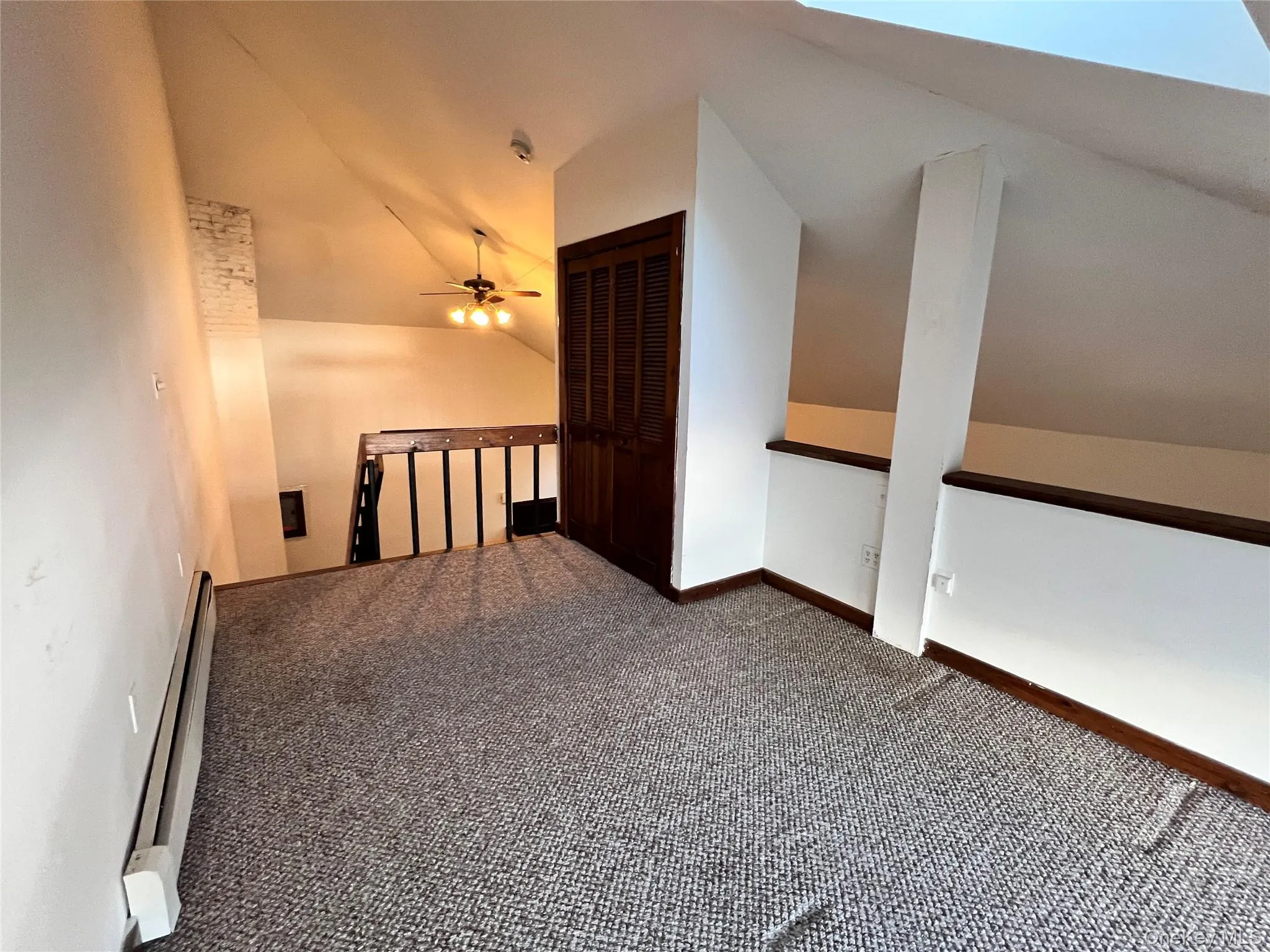 Bonus room with carpet floors, baseboard heating, and lofted ceiling Bonus room with carpet floors, baseboard heating, and lofted ceiling