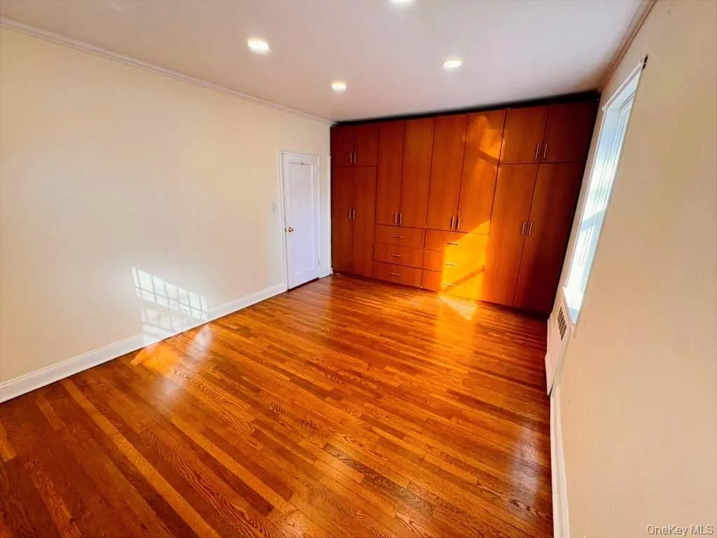 Unfurnished bedroom featuring light wood-style flooring, recessed lighting, and ornamental molding Unfurnished bedroom featuring light wood-style flooring, recessed lighting, and ornamental molding