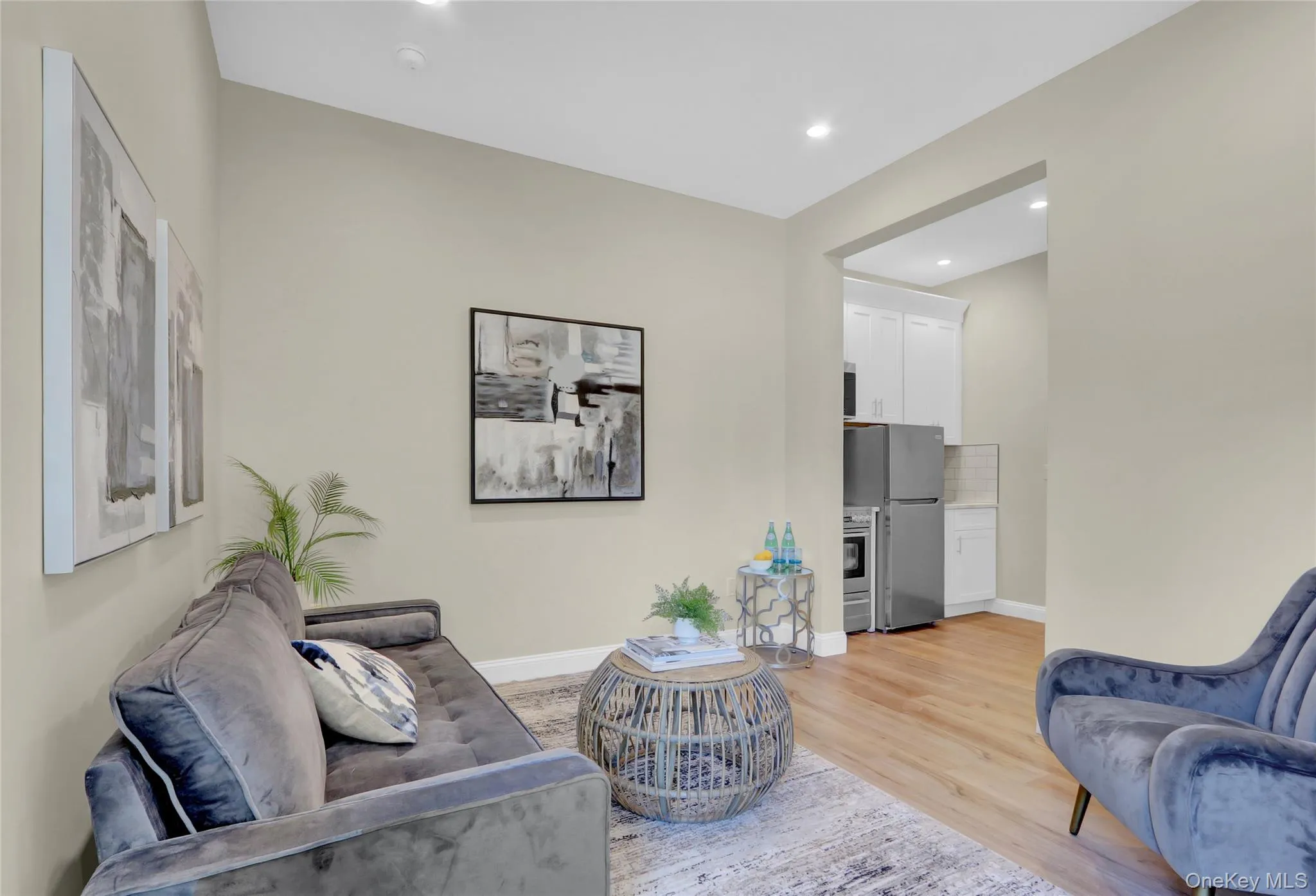 Living area with light wood-style flooring and recessed lighting Living area with light wood-style flooring and recessed lighting
