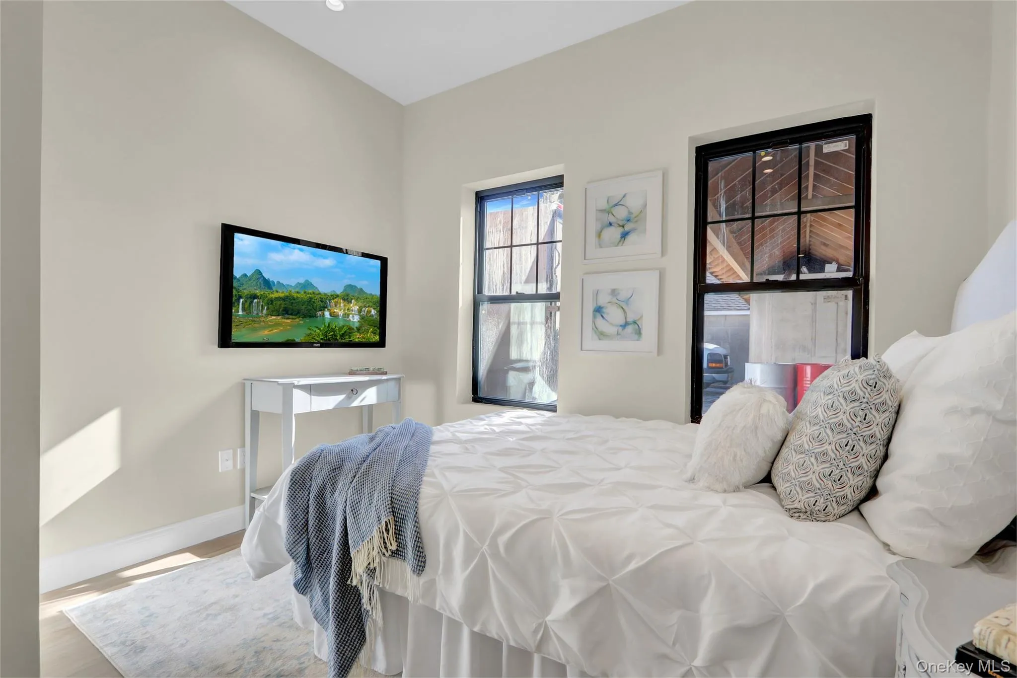 Bedroom featuring baseboards and wood finished floors Bedroom featuring baseboards and wood finished floors