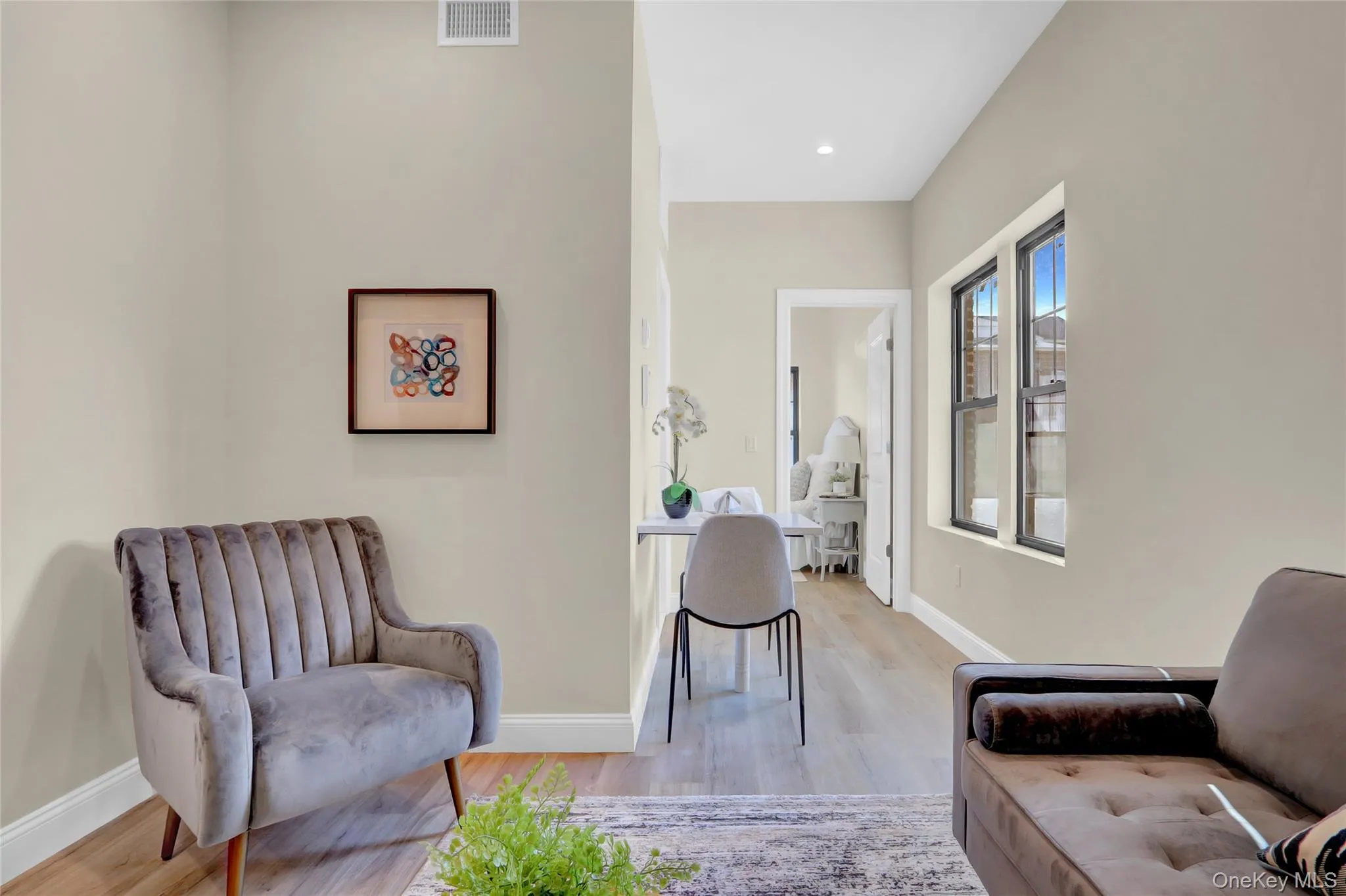 Living area featuring wood finished floors and baseboards Living area featuring wood finished floors and baseboards