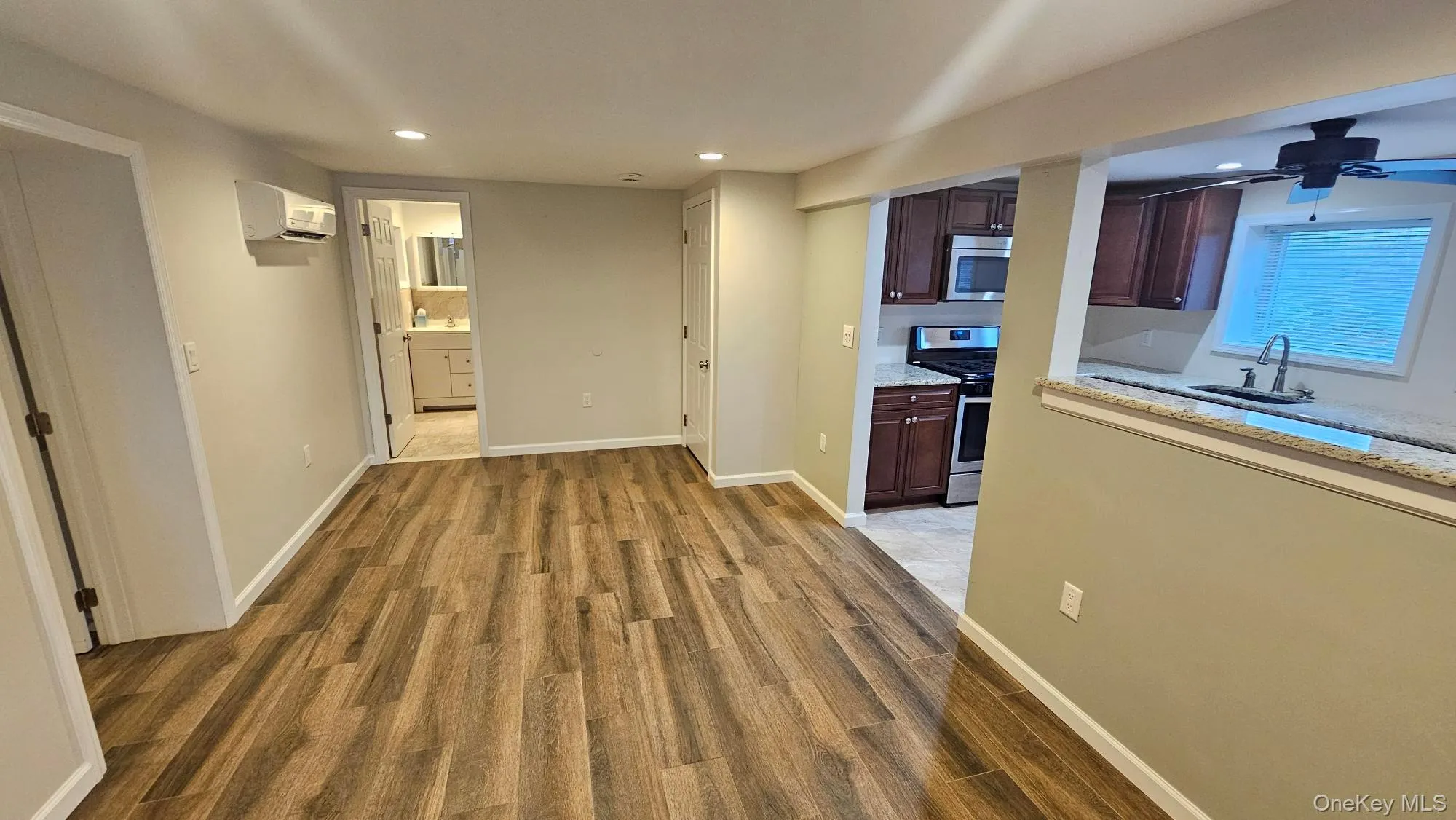 Hall with light wood-style floors and recessed lighting Hall with light wood-style floors and recessed lighting