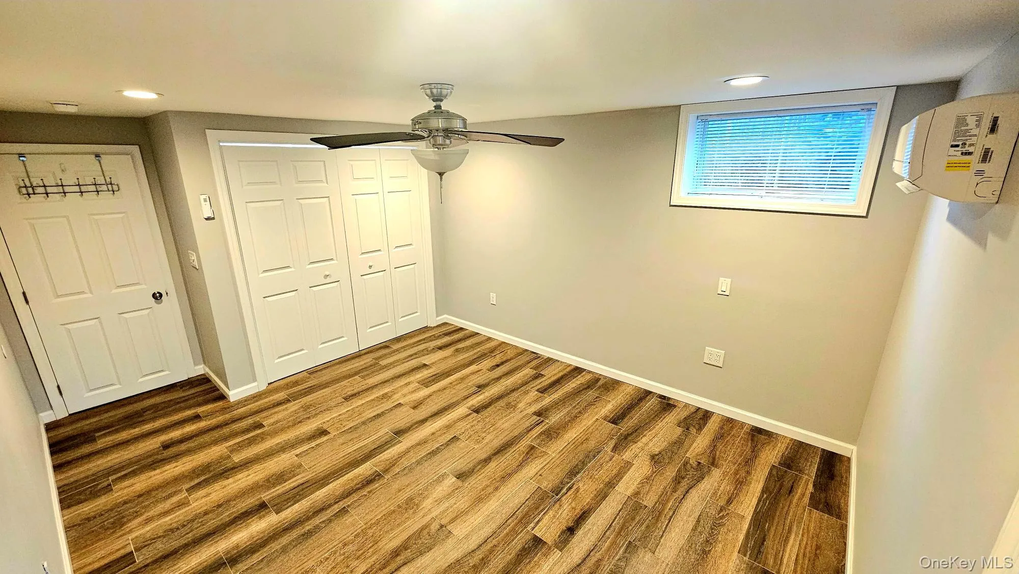 Unfurnished bedroom featuring wood finished floors, a closet, recessed lighting, and ceiling fan, Ductless Heat & A/C Unfurnished bedroom featuring wood finished floors, a closet, recessed lighting, and ceiling fan, Ductless Heat & A/C