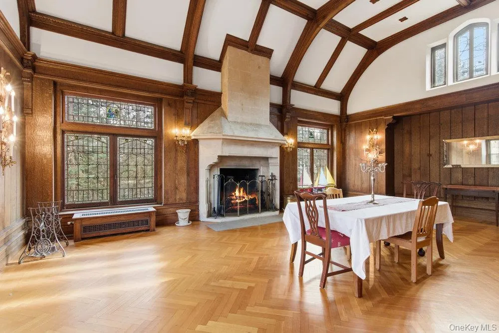 Banquet sized Dining room with high vaulted ceiling, and a large fireplace, leaded glass windows with stained glass accents Banquet sized Dining room with high vaulted ceiling, and a large fireplace, leaded glass windows with stained glass accents