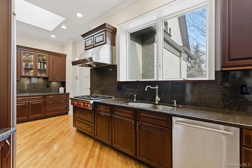 Kitchen featuring hi end stainless steel appliances hardwood floors and lots of cabinetry Kitchen featuring hi end stainless steel appliances hardwood floors and lots of cabinetry