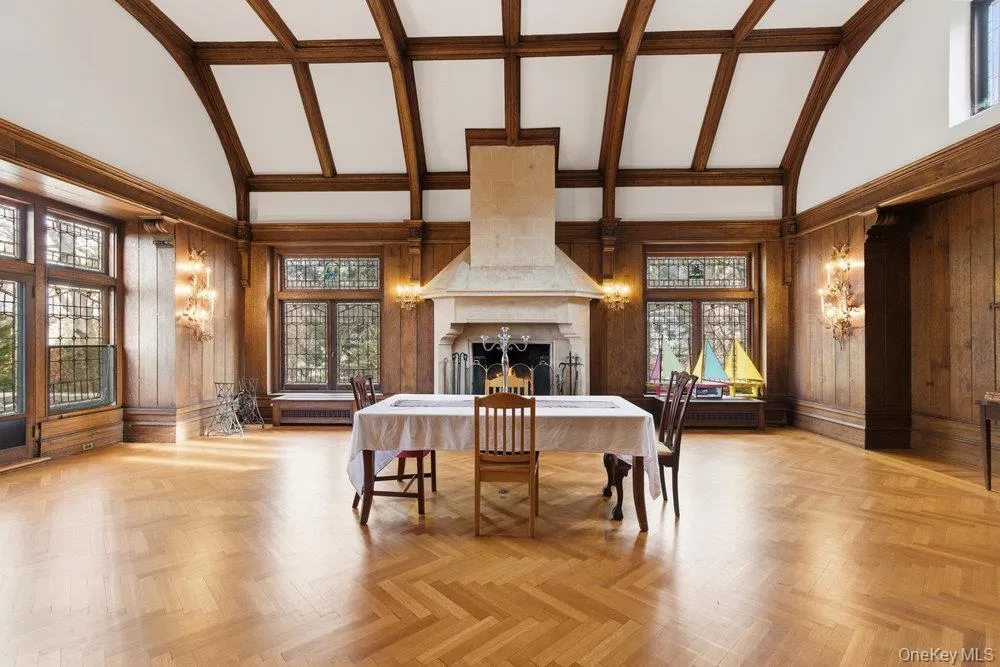Banquet sized Dining room featuring high vaulted ceiling, old growth forest wood walls, plenty of original herringbone oak floors, tons natural light, and a large fireplace Banquet sized Dining room featuring high vaulted ceiling, old growth forest wood walls, plenty of original herringbone oak floors, tons natural light, and a large fireplace