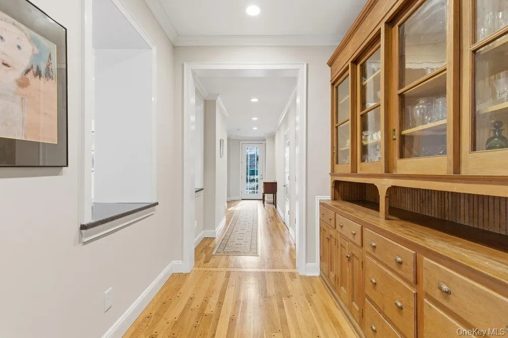 Entry Hall featuring ornamental molding, wood floors, recessed lighting & a butler's pantry Entry Hall featuring ornamental molding, wood floors, recessed lighting & a butler's pantry