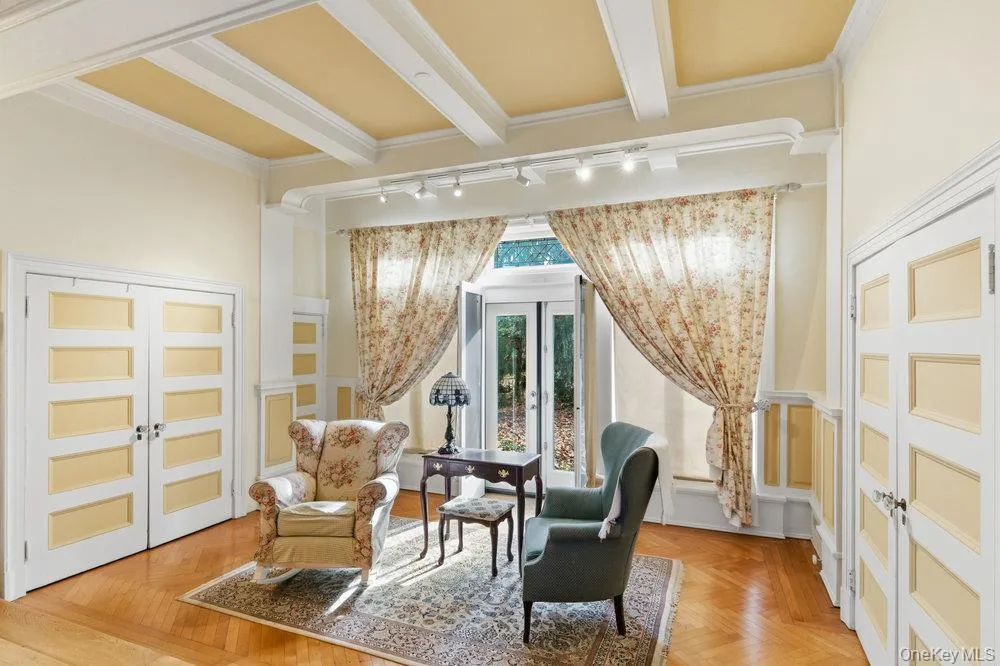 Sitting room featuring french doors with leaded glass accents, beamed ceiling Sitting room featuring french doors with leaded glass accents, beamed ceiling